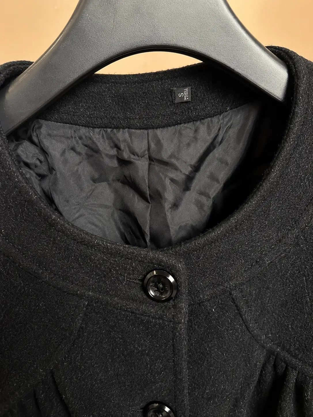 Construction detail of Black Wool Cropped Bow-Back Jacket