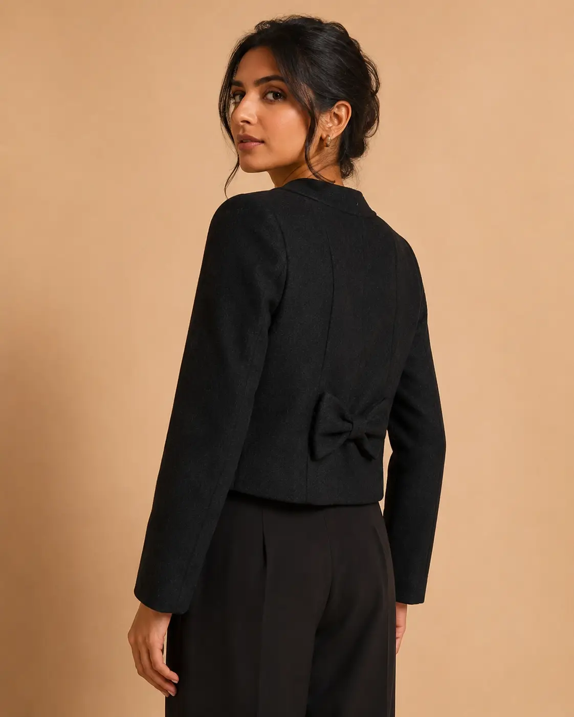 Model side view of Black Wool Cropped Bow-Back Jacket