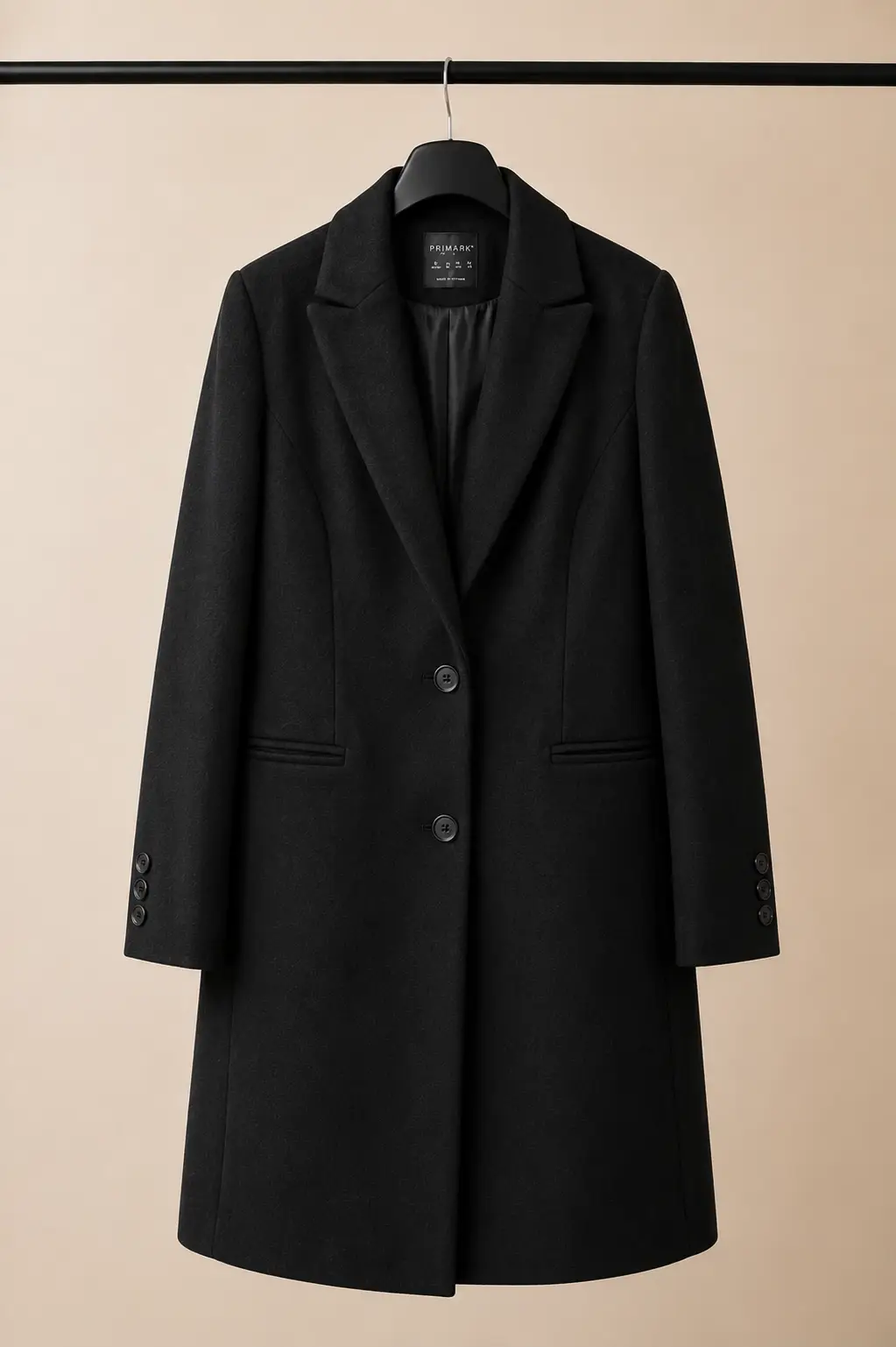 Front view of a Primark women's black tailored wool-blend coat with notch lapels, two-button fastening and horizontal welt pockets at OXFITTER Pakistan.