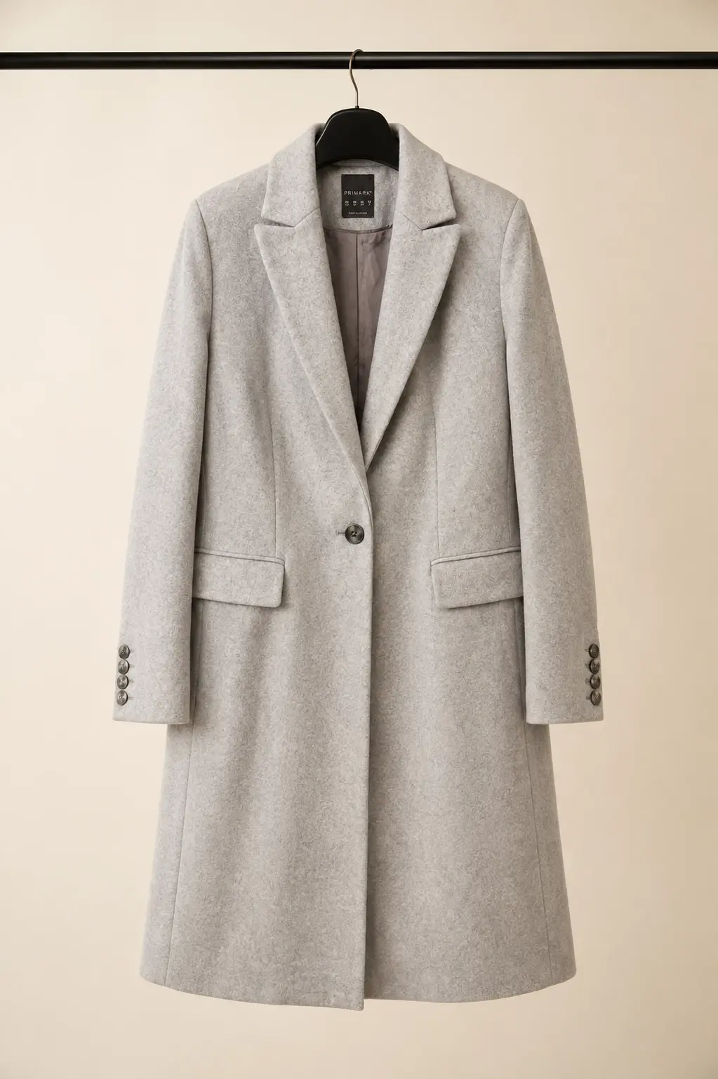 Front view of a Primark women's light heather grey tailored wool-blend coat with notch lapels, two-button fastening and horizontal welt pockets at OXFITTER Pakistan.